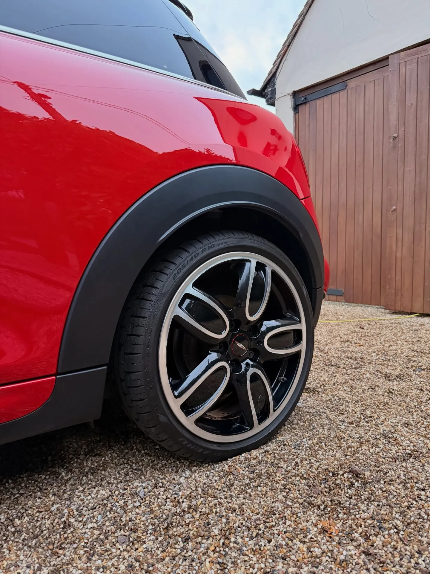 Cleaned alloy wheel and arch on a red Mini Cooper